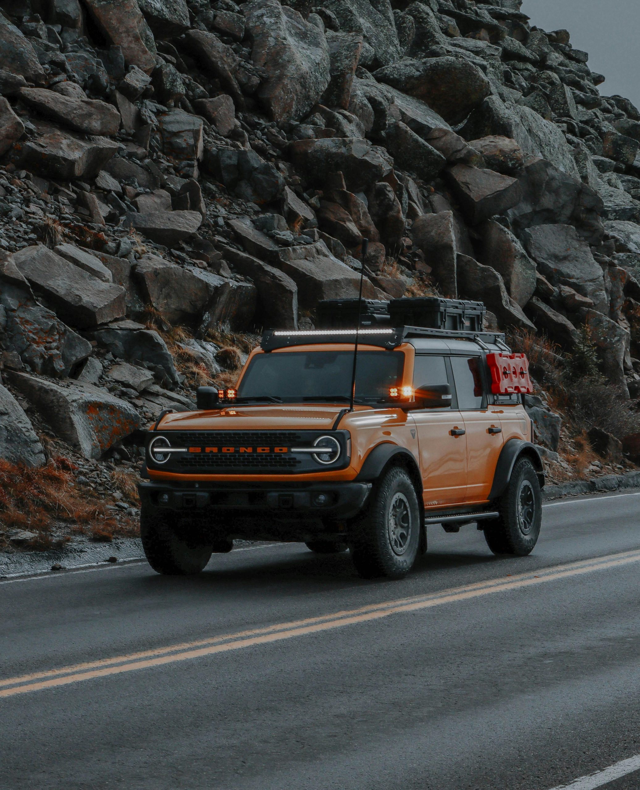 Orange Ford Bronco on Road in Mountains in Colorado, USA